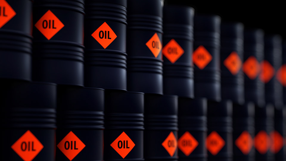 A stack of black oil barrels 
